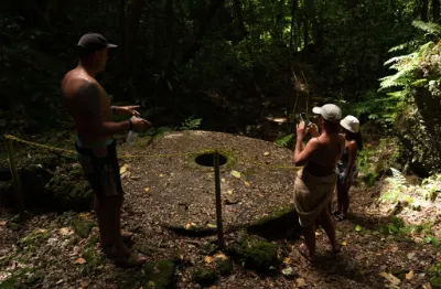 people standing around a stone money in Airai Palau