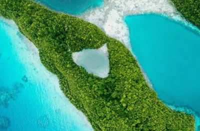 Aerial photo of an island and sandy turquoise bays