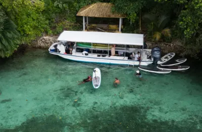 Palau Explorer boat and SUP in front of stone money