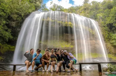 group of people in front of the waterfall in Ngardmau, Palau