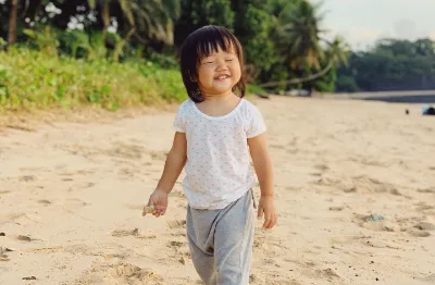 child being happy on the beach