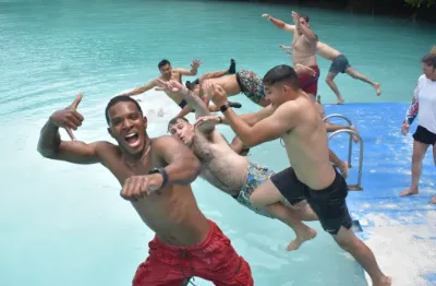group of people having fun jumping in the ocean at Milky Way Palau